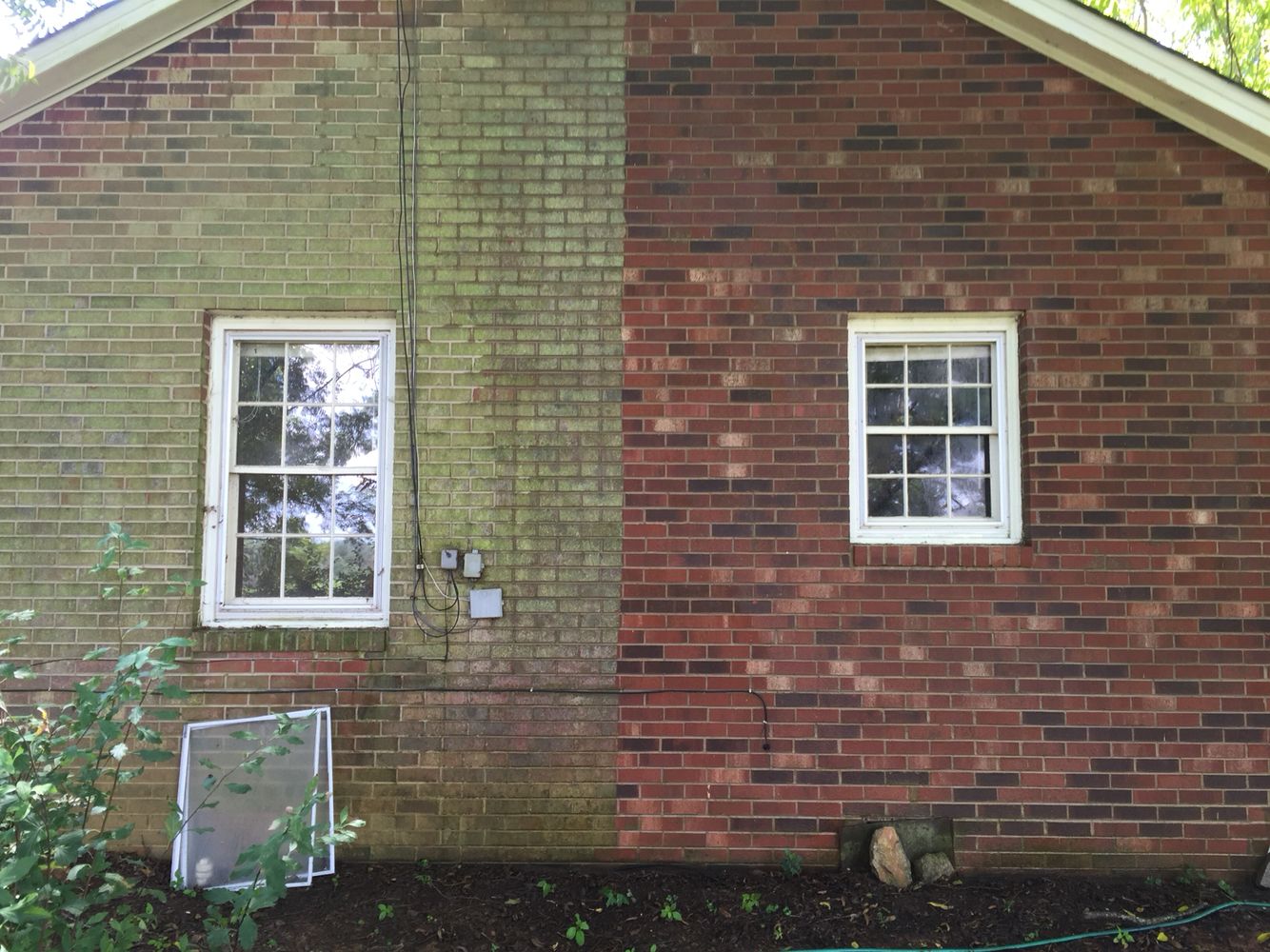 Before and after brick wall power washing showing dramatic transformation