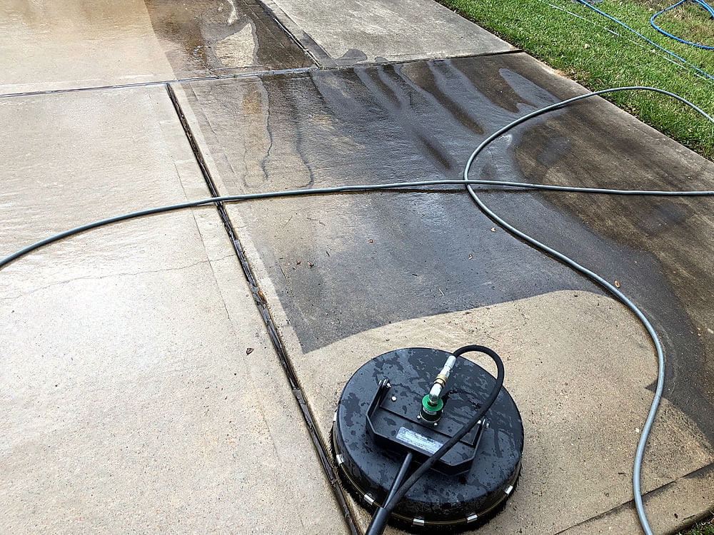 Concrete driveway showing clean versus dirty contrast after power washing